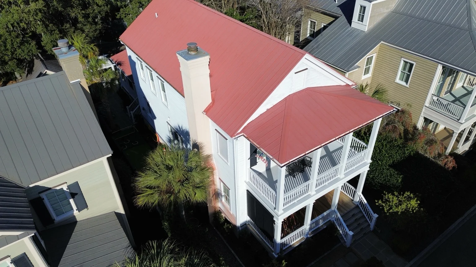 Red metal roof on a white raised Lowcountry home